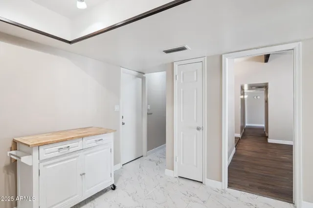 a view of a hallway with closet and wooden floor