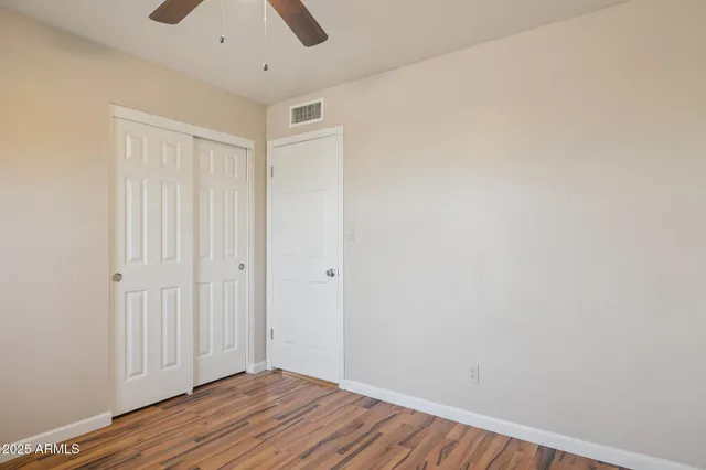 a view of a room with wooden floor