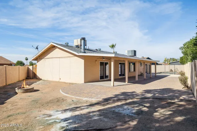 a view of a house with backyard and sitting area