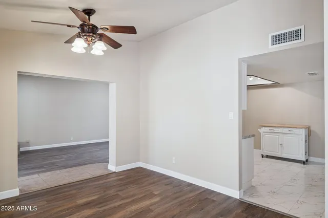 a view of an empty room and wooden floor