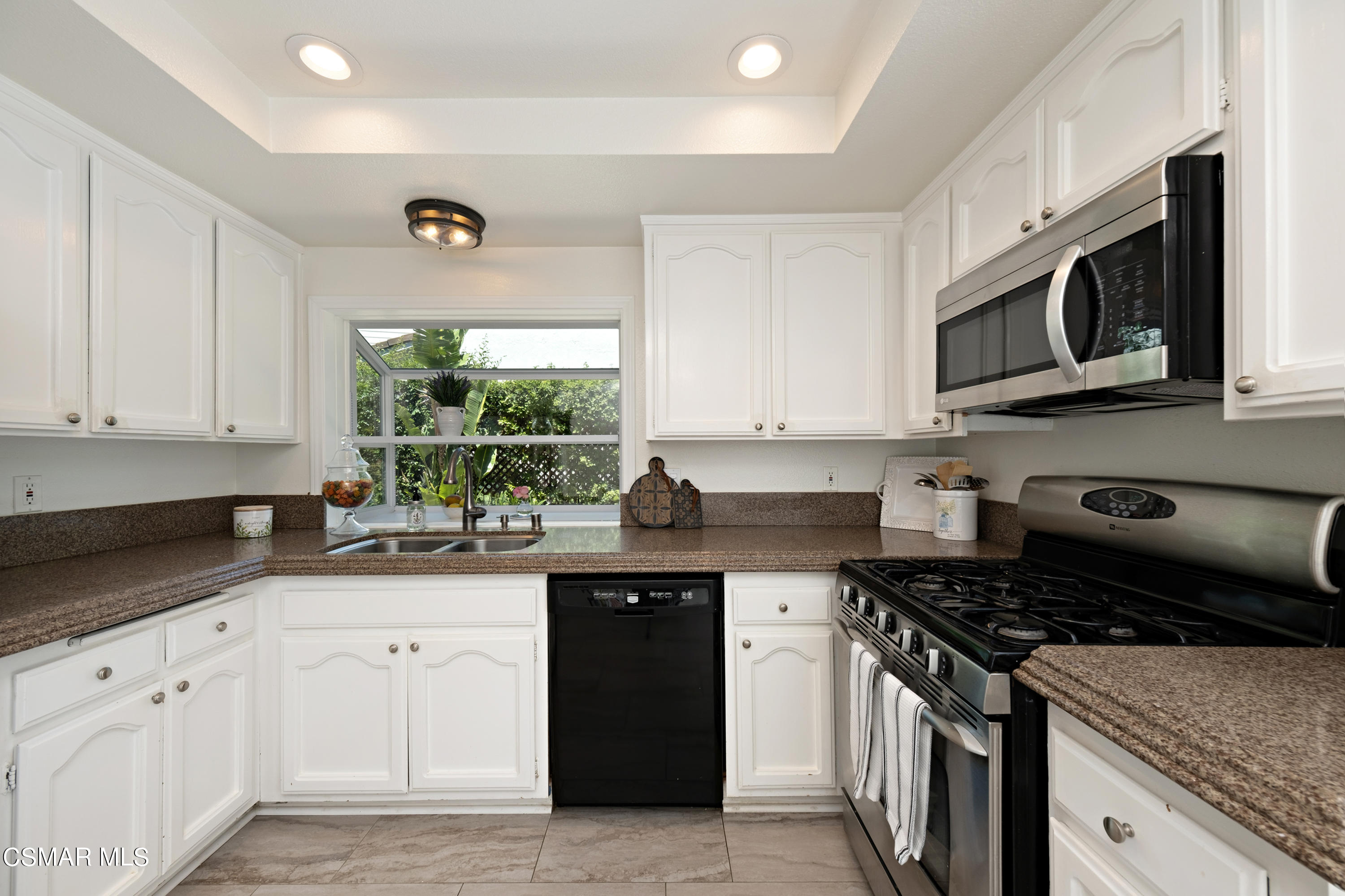 19358 Crystal Ridge Lane Porter Ranch, CA 91326 - Photo 14 of 37 a kitchen with stainless steel appliances granite countertop a sink stove and microwave