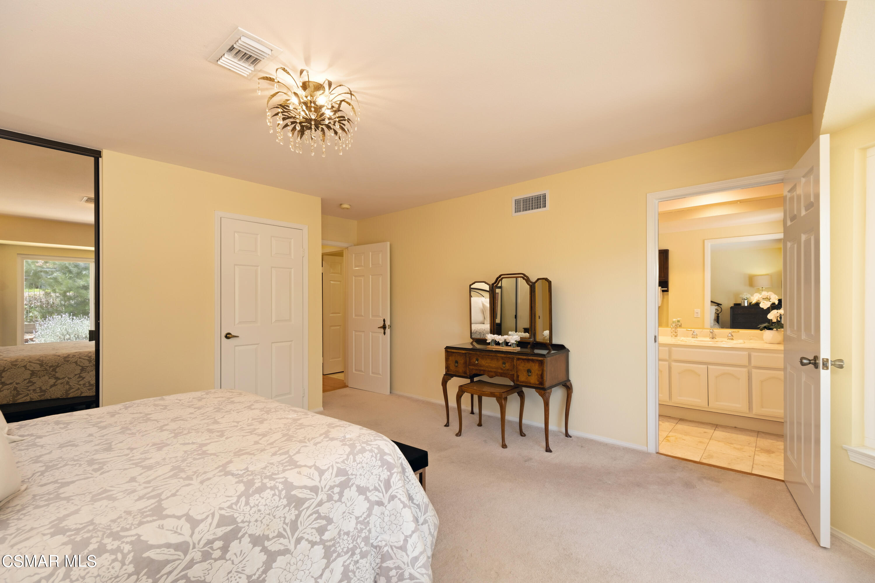 19358 Crystal Ridge Lane Porter Ranch, CA 91326 - Photo 25 of 37 a bedroom with a bed and a chandelier