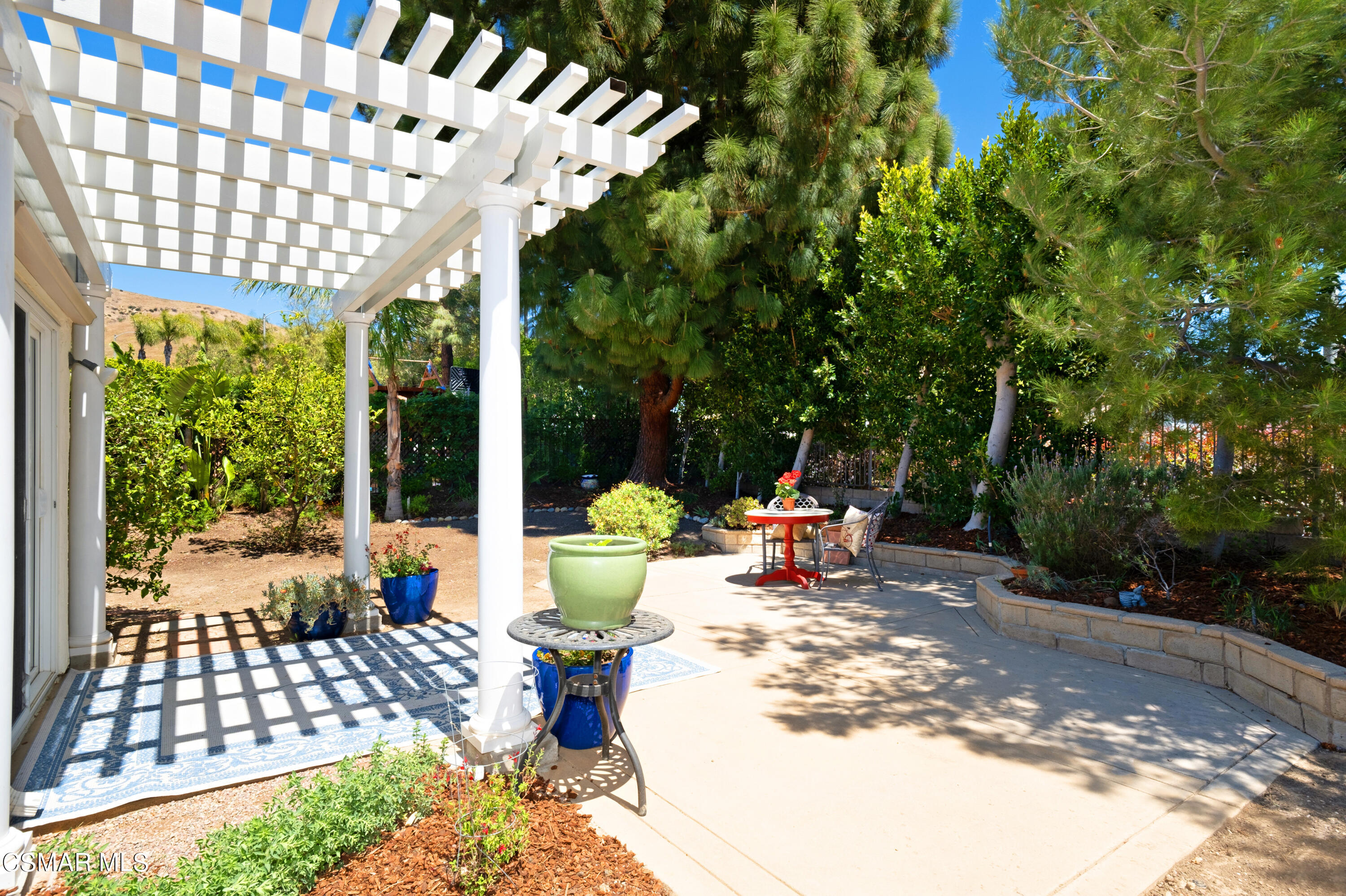 19358 Crystal Ridge Lane Porter Ranch, CA 91326 - Photo 29 of 37 a view of a patio with table and chairs and potted plants