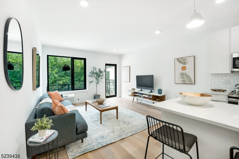 803 South Avenue, Unit 503 Plainfield, NJ 07062 - Photo 7 of 45 a living room with furniture and a flat screen tv