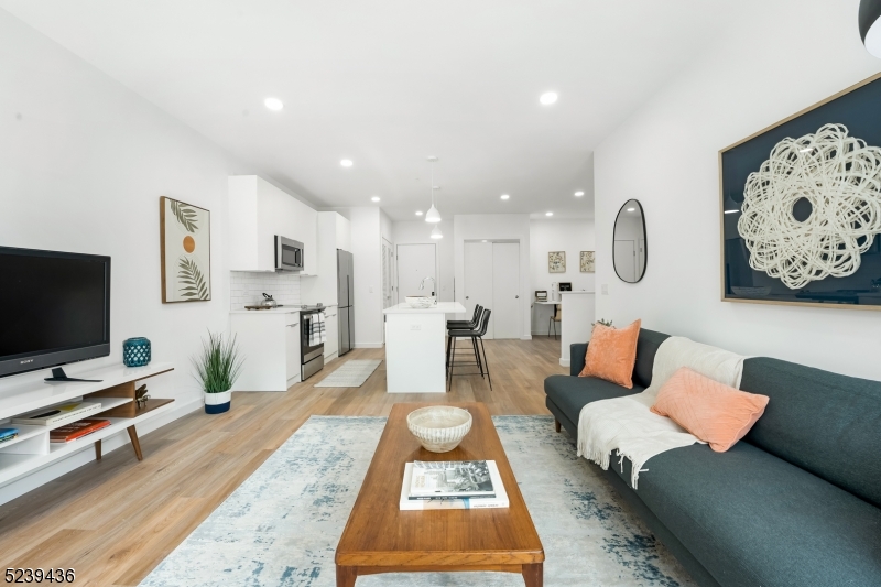 803 South Avenue, Unit 503 Plainfield, NJ 07062 - Photo 8 of 45 a living room with furniture and a flat screen tv
