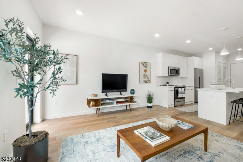 803 South Avenue, Unit 503 Plainfield, NJ 07062 - Photo 10 of 45 a living room with furniture and a flat screen tv