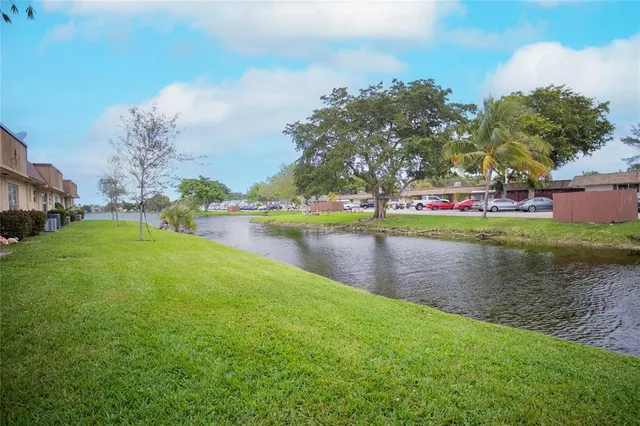 a view of a lake with houses in back