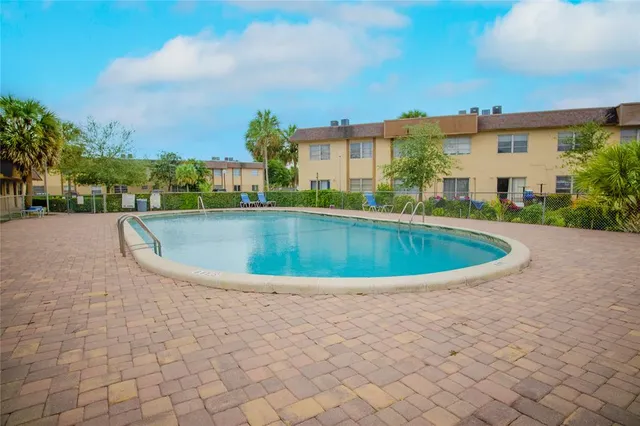 a swimming pool with outdoor seating and yard