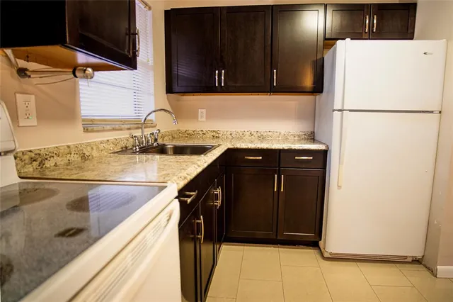 a kitchen with a refrigerator and a sink