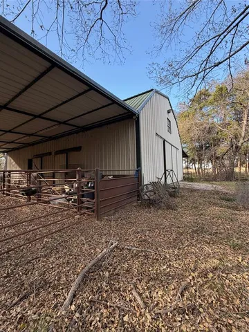 a view of a yard with large trees