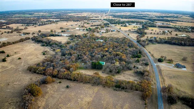 a view of a field with trees in the background