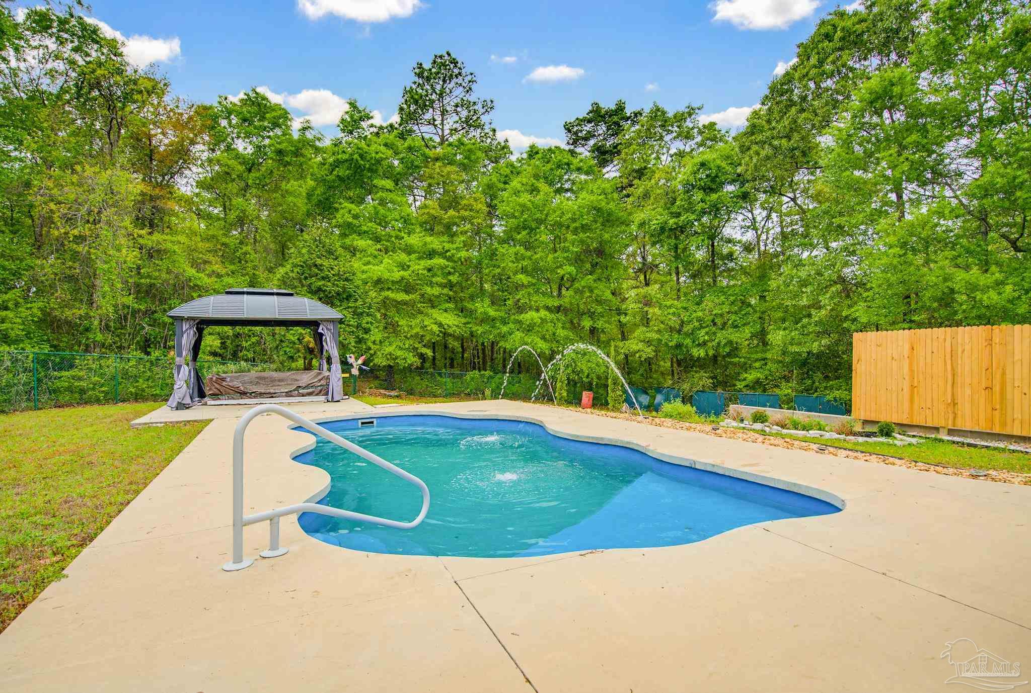 2855 Walling Road Milton, FL 32570 - Photo 5 of 55 a view of a swimming pool with a yard