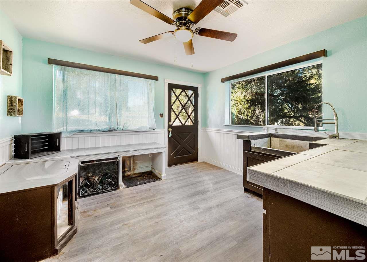 2220 Lousetown Road Reno, NV 89521 - Photo 9 of 22 a kitchen with a stove a sink and a refrigerator