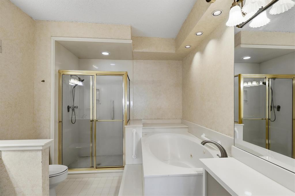 5200 Keller Springs Road, Unit 1315 Dallas, TX 75248 - Photo 13 of 40 a bathroom with a bathtub shower sink vanity and toilet