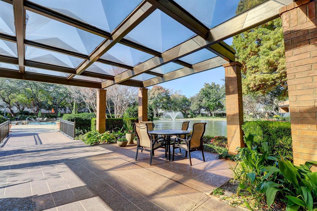 5200 Keller Springs Road, Unit 1315 Dallas, TX 75248 - Photo 34 of 40 a view of a patio with table and chairs potted plants with floor to ceiling window