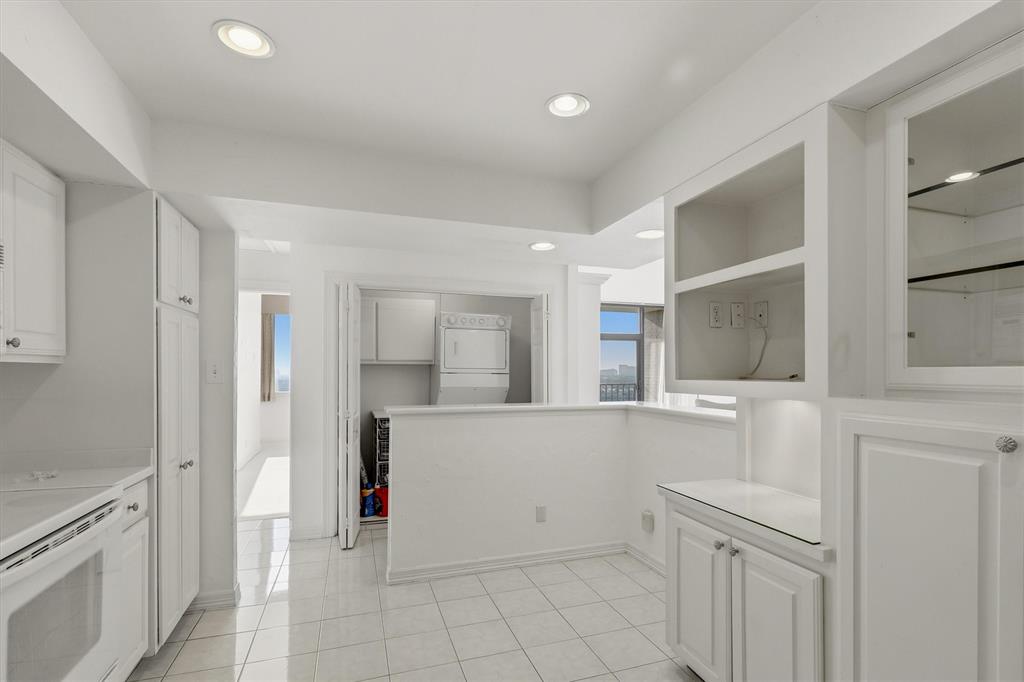 5200 Keller Springs Road, Unit 1315 Dallas, TX 75248 - Photo 8 of 40 a kitchen with white cabinets and sink