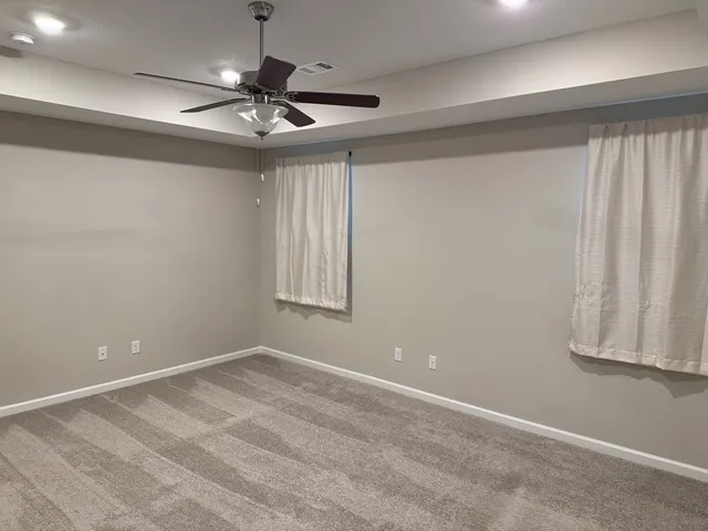 a view of room with window and ceiling fan