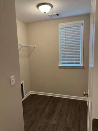 a view of a room with wooden floor and windows
