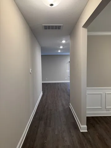 a view of hallway with wooden floor