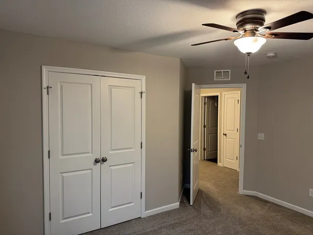 a view of a livingroom with a chandelier fan