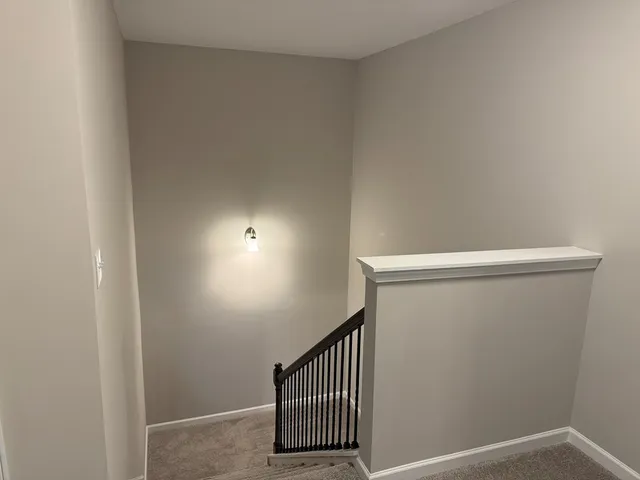 a view of staircase with wooden floor
