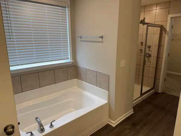 a bathroom with a bathtub and a shower