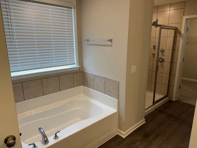 a bathroom with a bathtub and a shower
