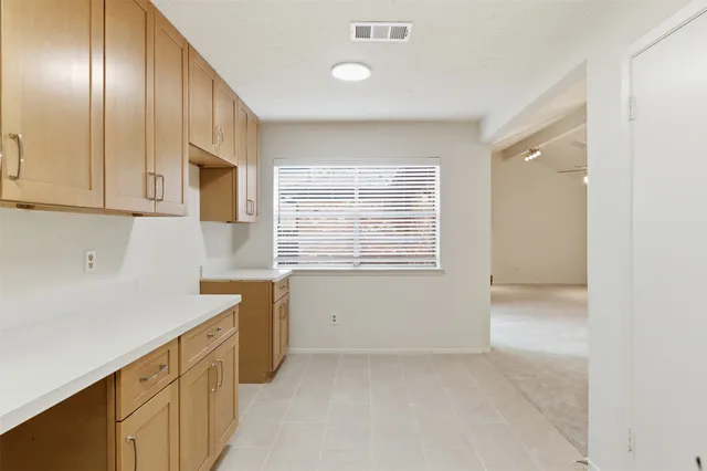 a view of a kitchen with dishwasher and white cabinets