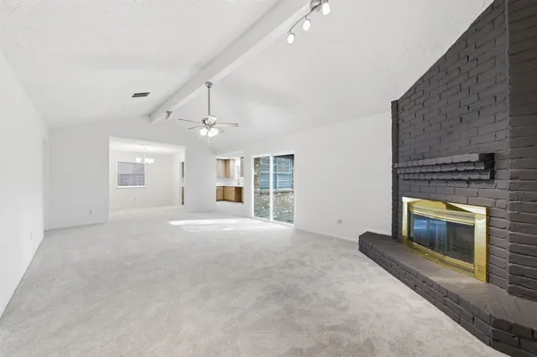 a view of an empty room with a fireplace
