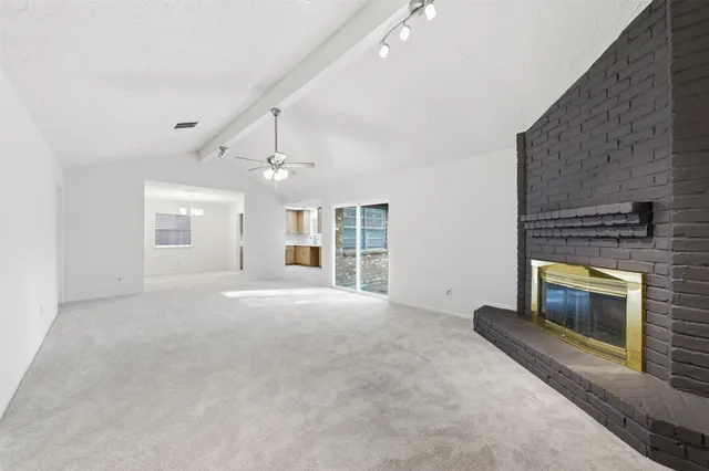 a view of an empty room with a fireplace