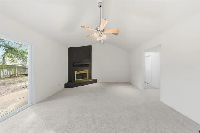 a view of a room with a ceiling fan and a window