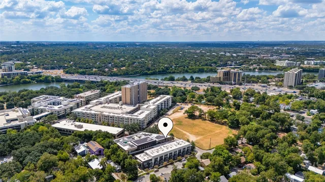 an aerial view of a house with a garden and lake view