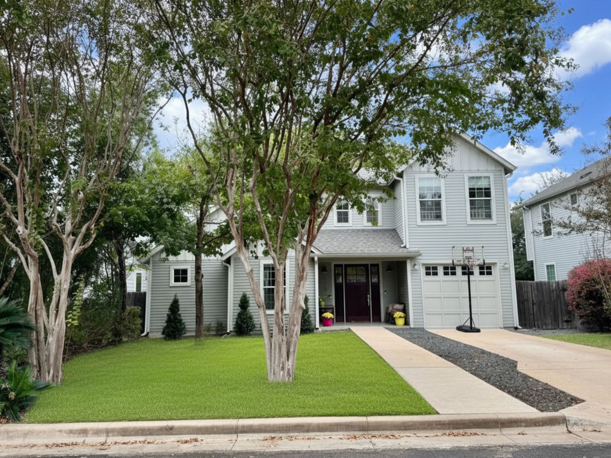 3302 Funston Street Austin, TX 78703 - Photo 1 of 36 Two-story residence featuring light gray siding with white trim, a covered entry porch, and an attached garage