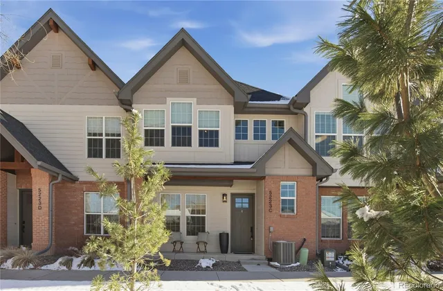 a view of a white house next to a yard