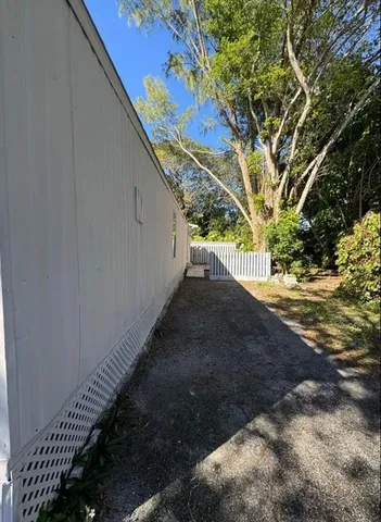 a view of a yard with large trees
