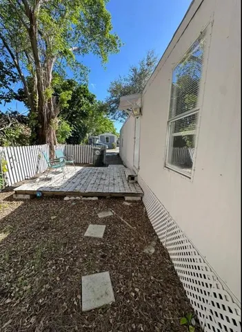 a bathroom with a granite countertop sink mirror vanity and toilet