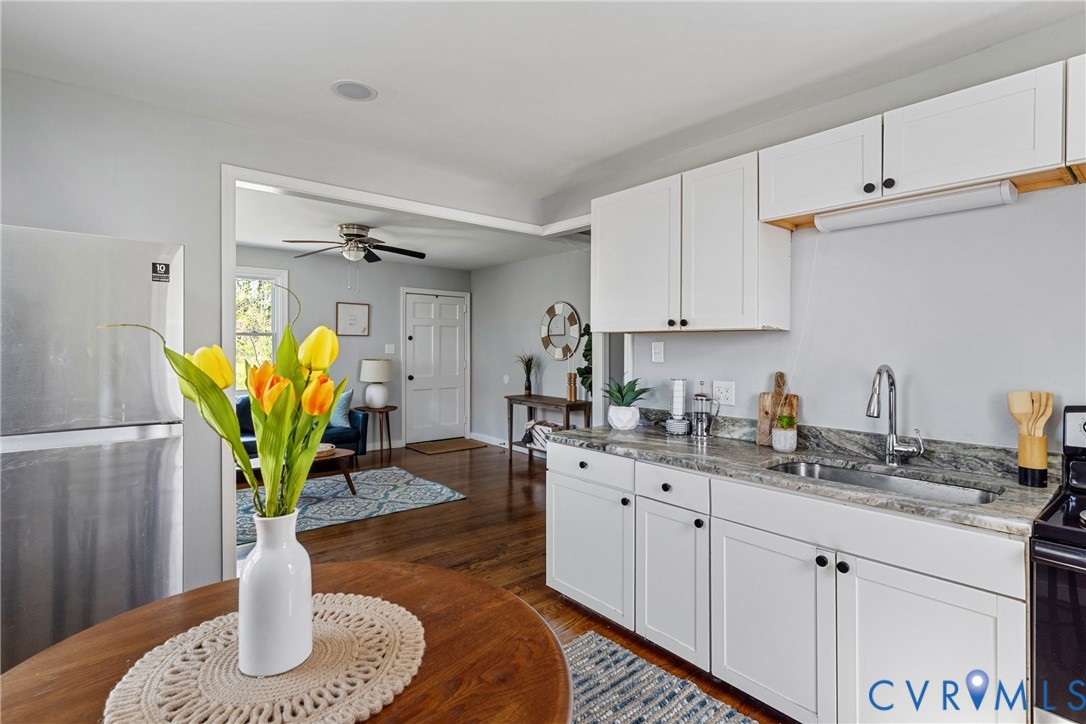2700 Berry Road Richmond, VA 23234 - Photo 18 of 46 a kitchen with stainless steel appliances granite countertop a potted plant on the granite counter a sink a dining table and chairs
