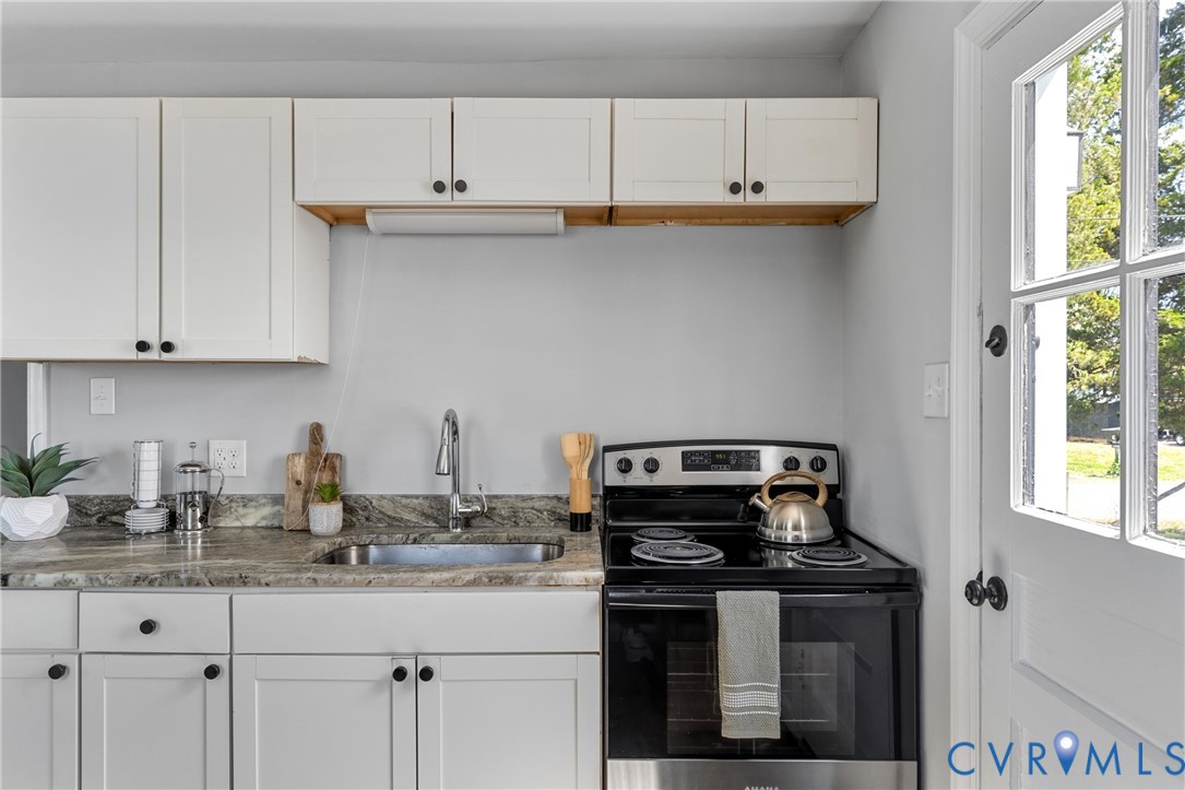 2700 Berry Road Richmond, VA 23234 - Photo 20 of 46 a kitchen with granite countertop a stove a sink and dishwasher
