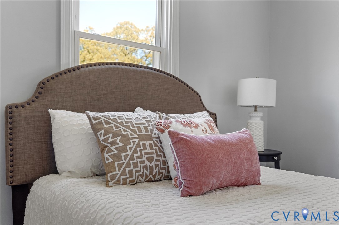 2700 Berry Road Richmond, VA 23234 - Photo 25 of 46 a bed sitting in a bedroom next to a window