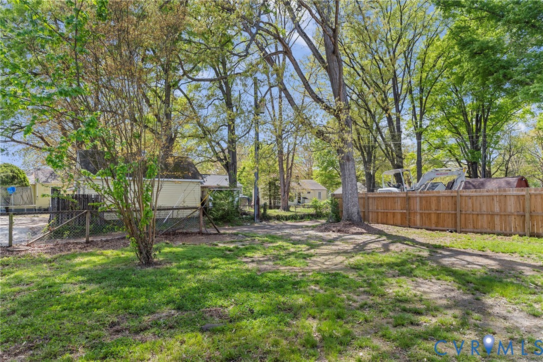 2700 Berry Road Richmond, VA 23234 - Photo 41 of 46 a view of a backyard with a table and chairs and a large tree