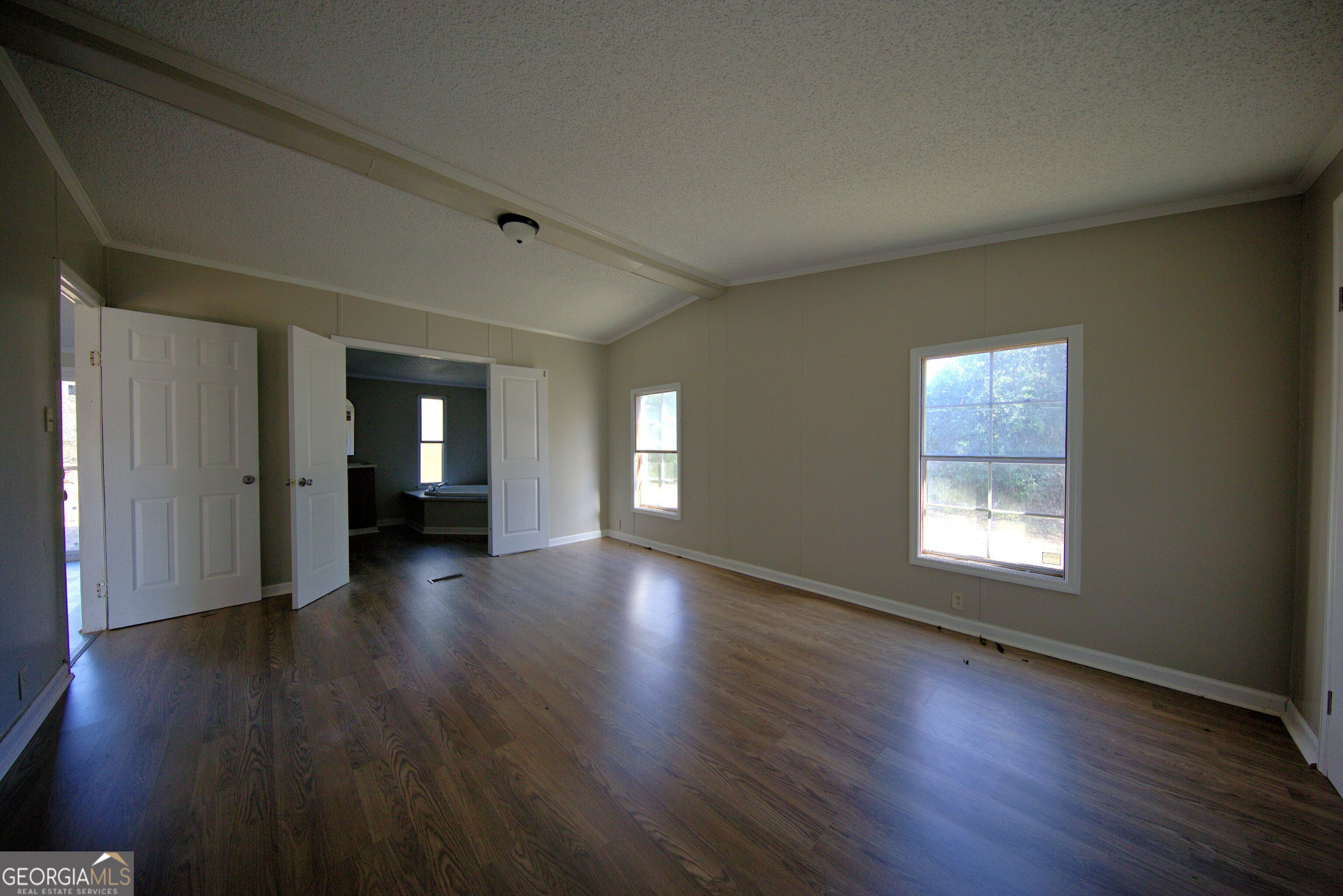 4702 Highway 65 Pelham, GA 31779 - Photo 3 of 21 a view of empty room with window and wooden floor