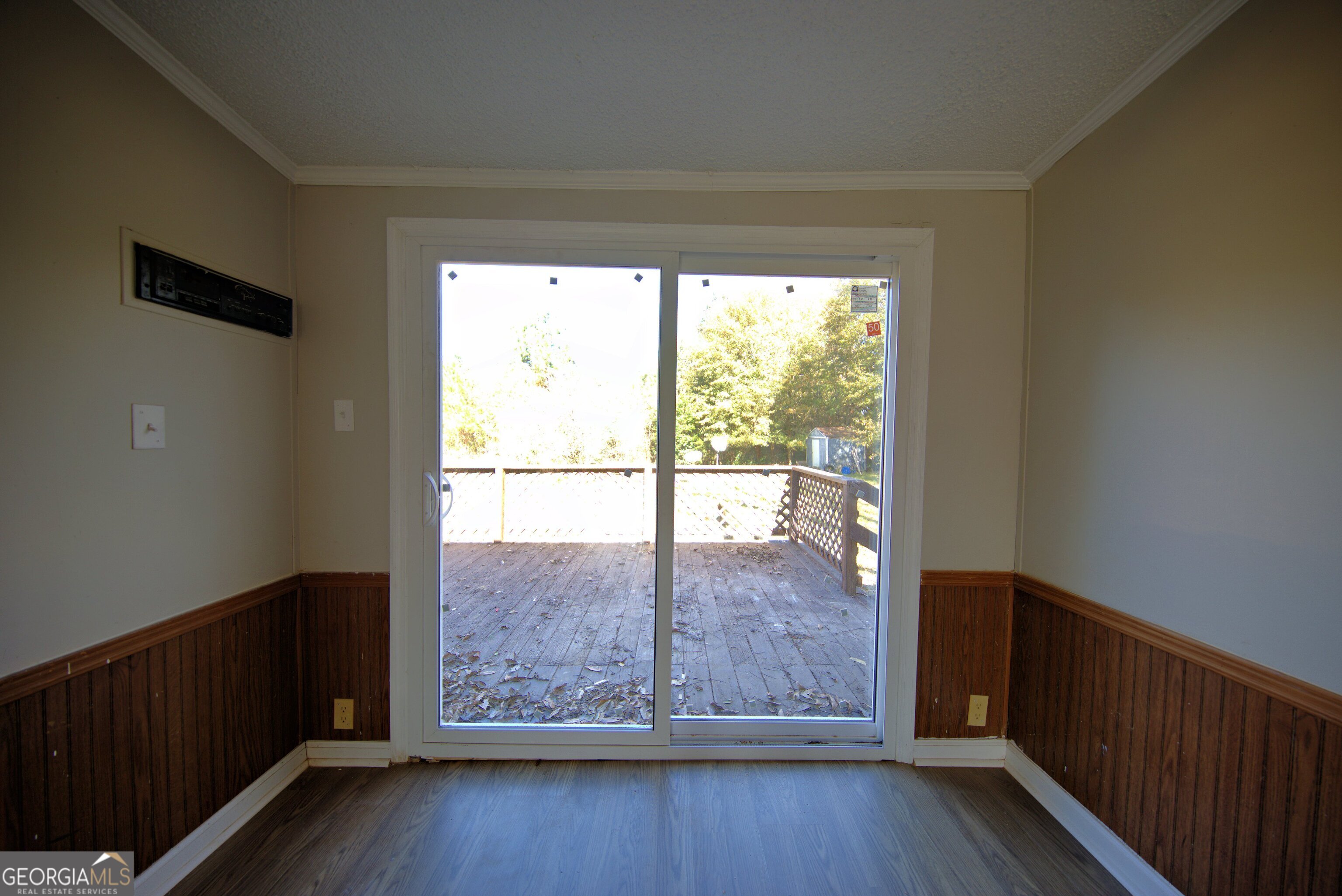 4702 Highway 65 Pelham, GA 31779 - Photo 6 of 21 a view of an empty room with wooden floor and a window