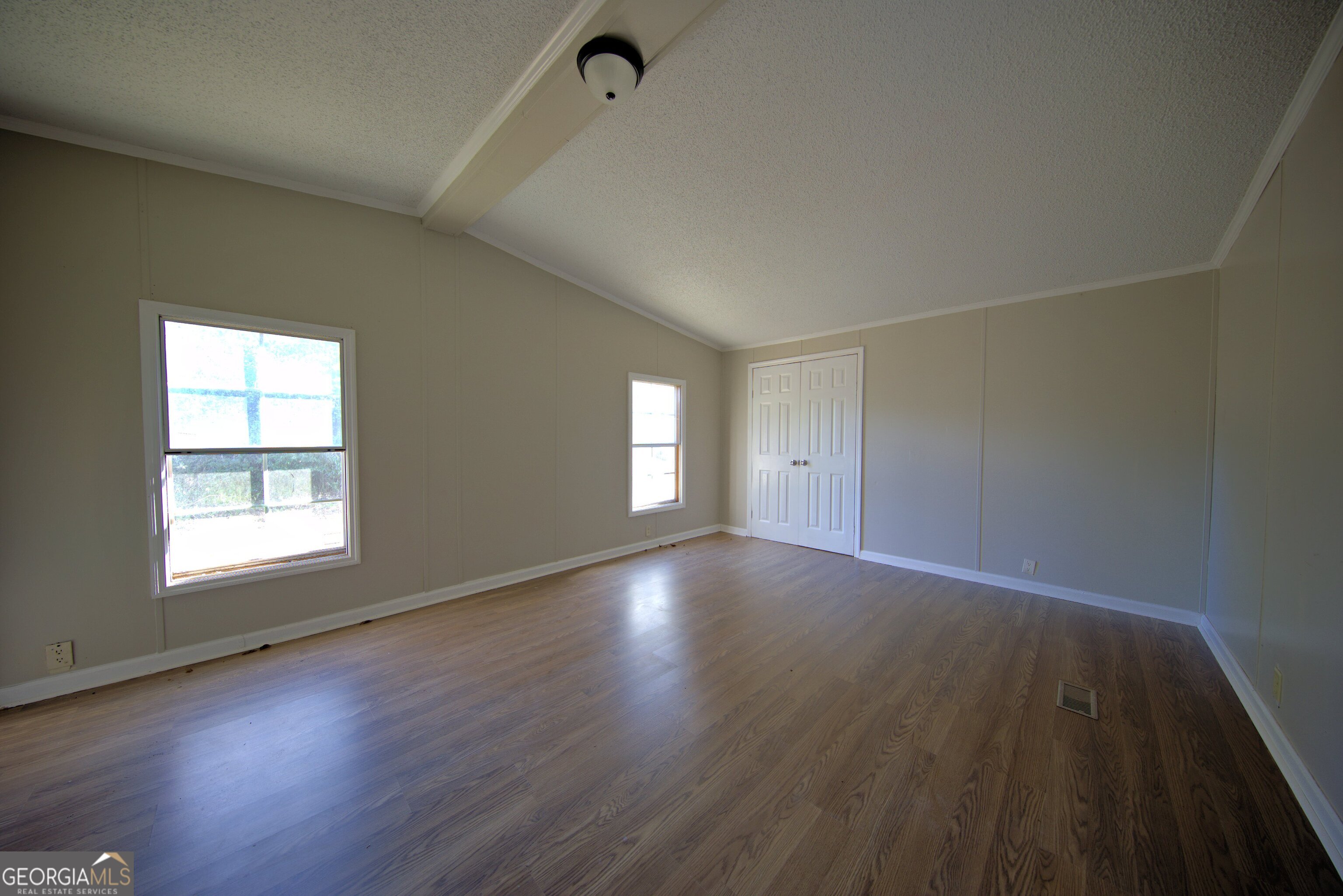 4702 Highway 65 Pelham, GA 31779 - Photo 8 of 21 an empty room with wooden floor and windows