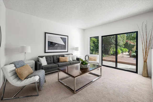 a bedroom with bed and a large window