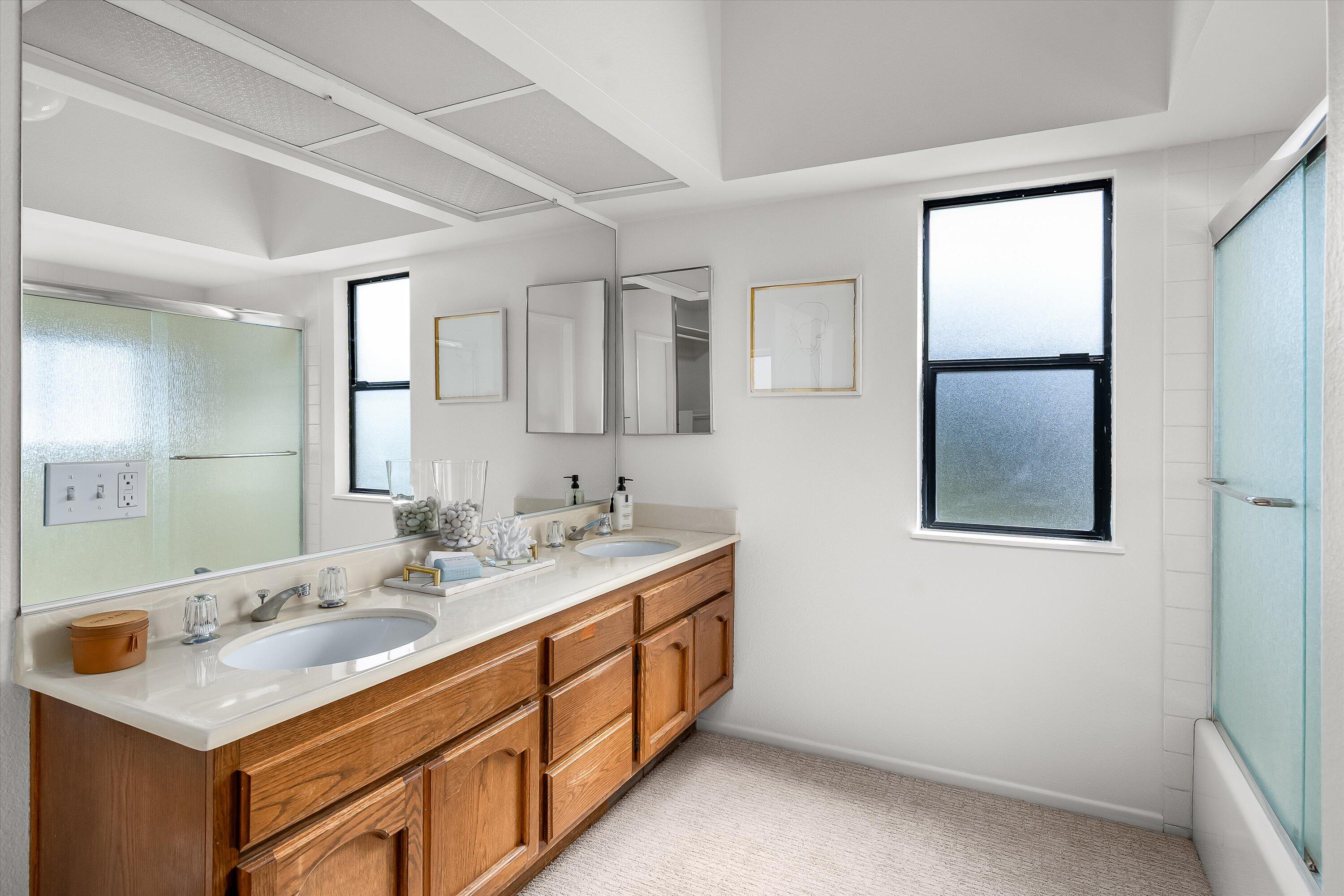 779 Dos Hermanos Road Santa Barbara, CA 93111 - Photo 15 of 33 a bathroom with a double vanity sink and mirror