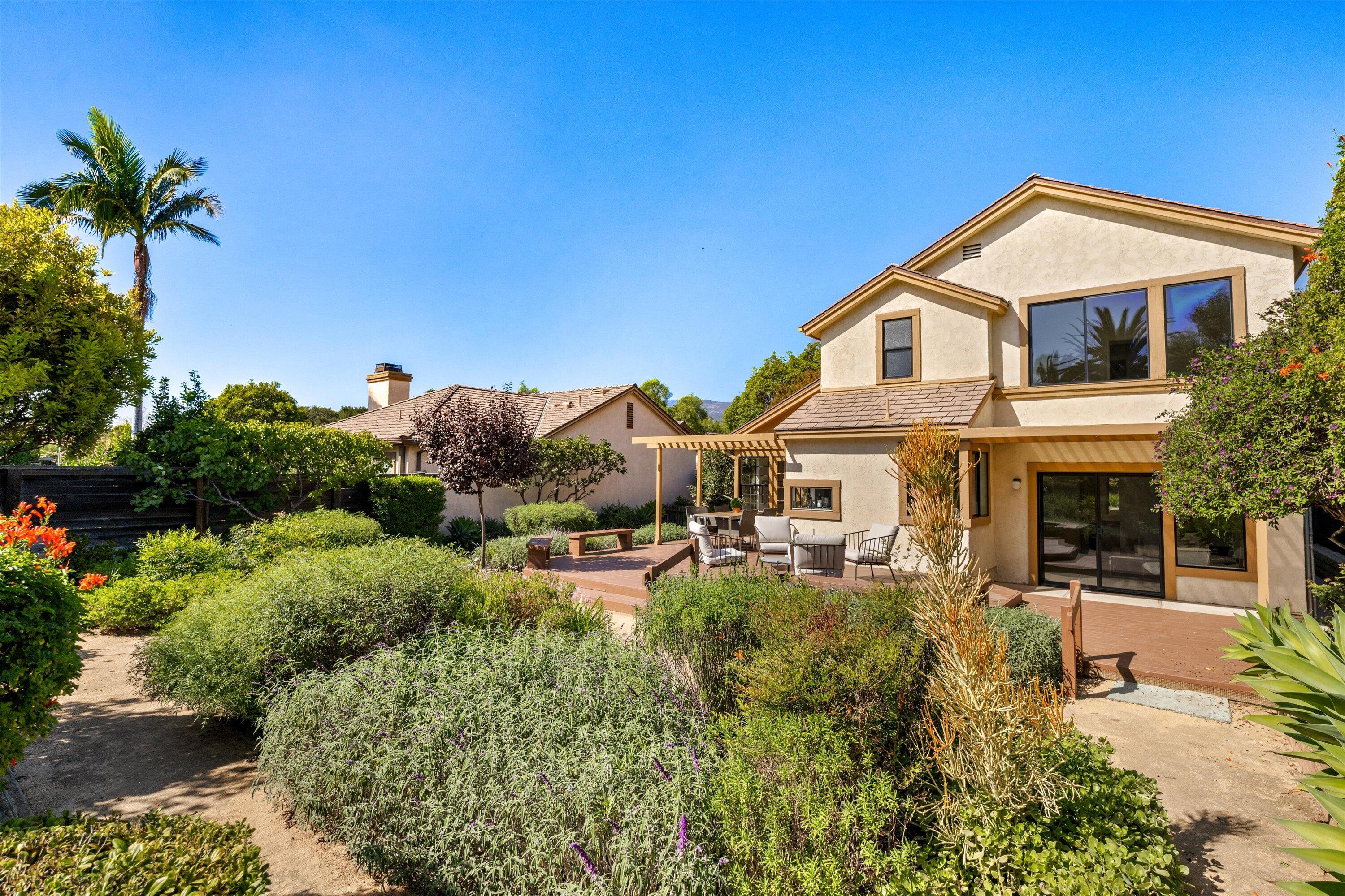 779 Dos Hermanos Road Santa Barbara, CA 93111 - Photo 27 of 33 a view of a house with a yard and potted plants