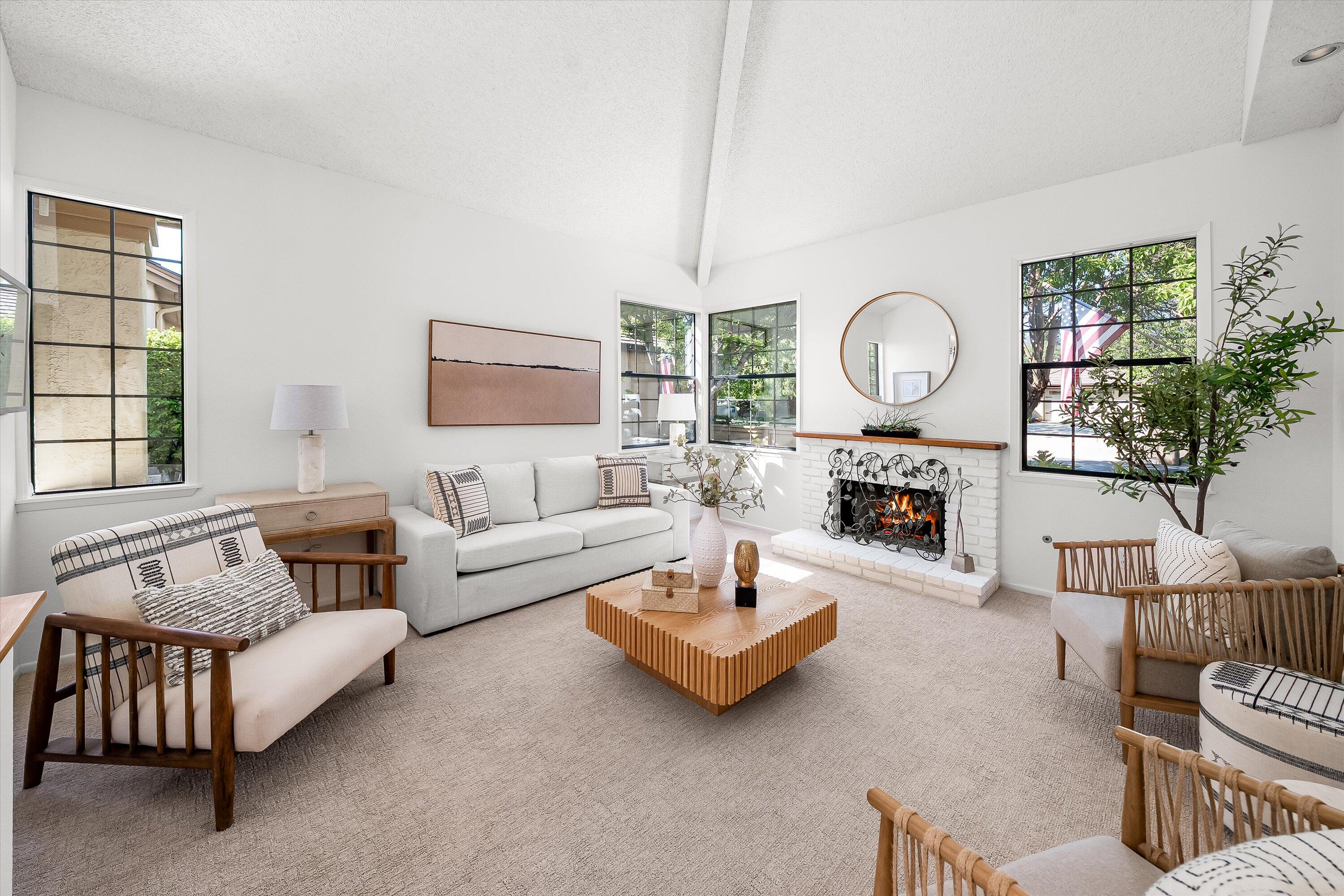 779 Dos Hermanos Road Santa Barbara, CA 93111 - Photo 5 of 33 a living room with furniture a fireplace and a large window