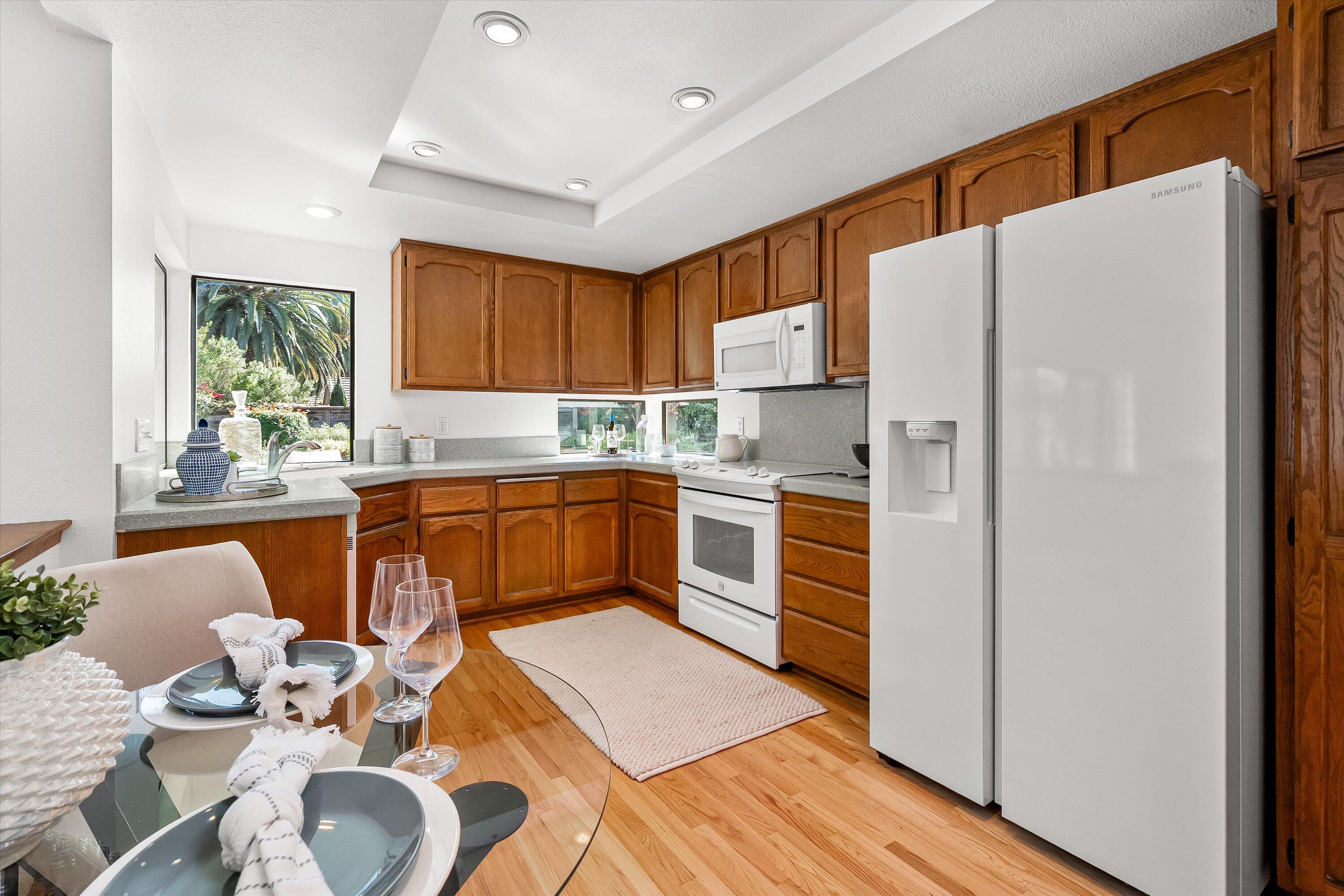 779 Dos Hermanos Road Santa Barbara, CA 93111 - Photo 10 of 33 a kitchen with stainless steel appliances granite countertop a refrigerator sink and white cabinets
