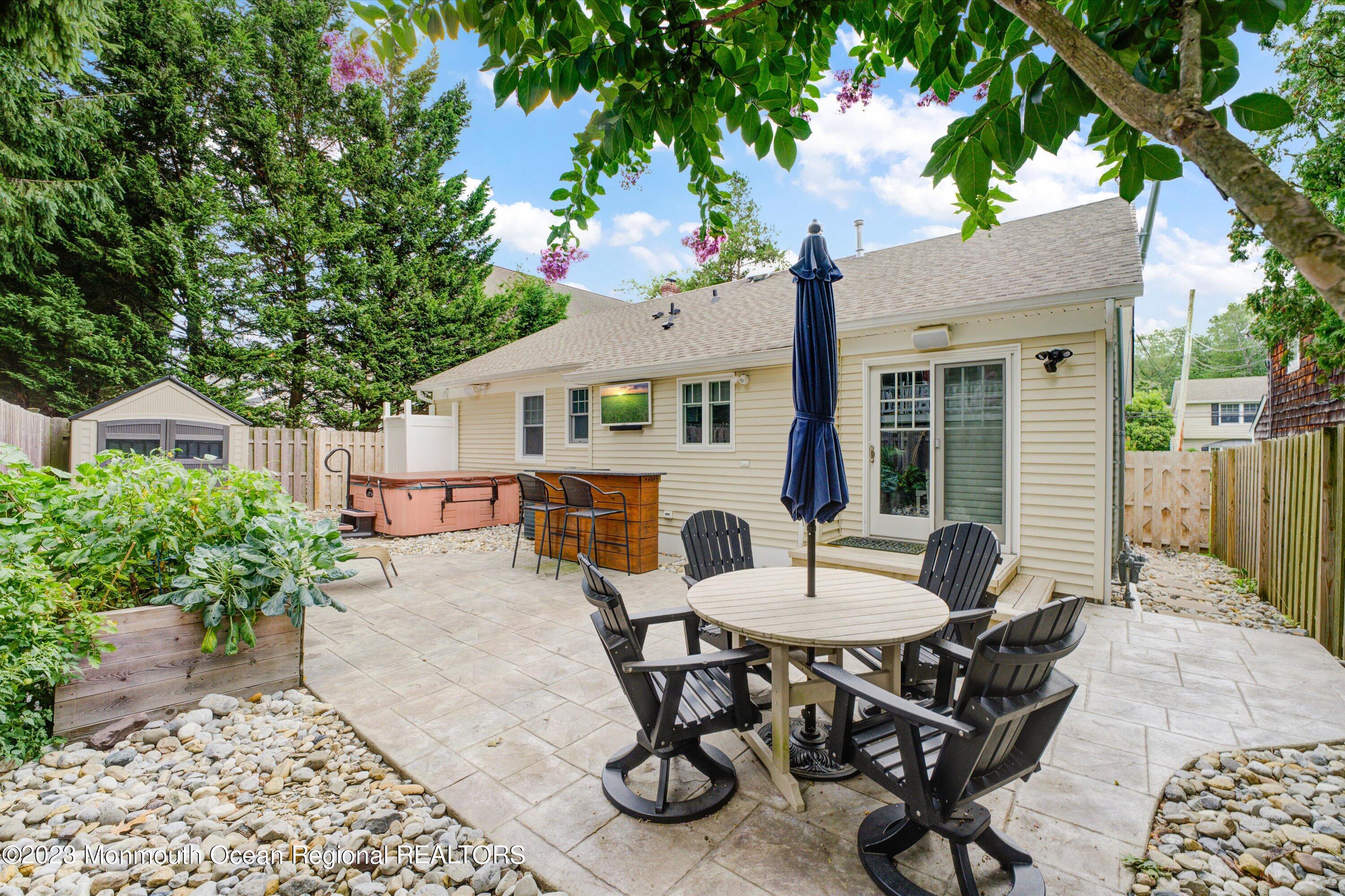 100 Manito Road Manasquan, NJ 08736 - Photo 19 of 28 a view of a patio with table and chairs and potted plants