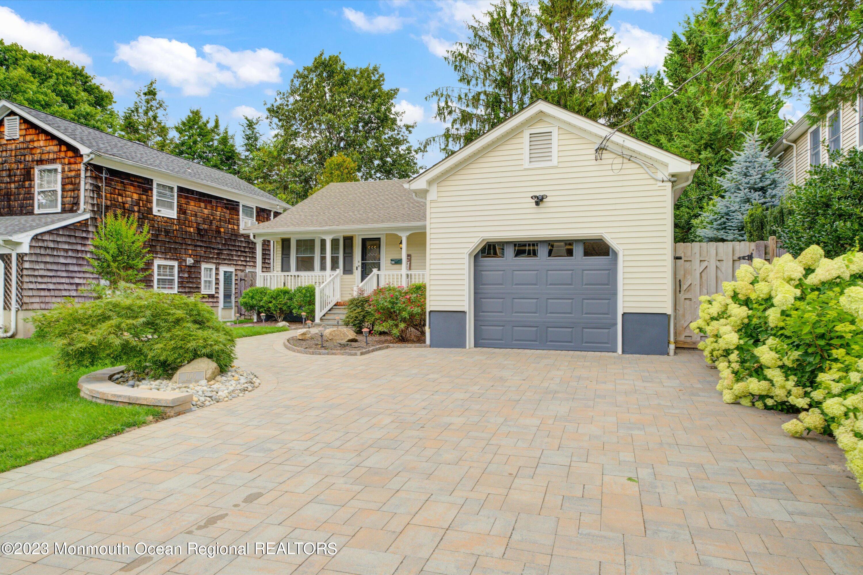 100 Manito Road Manasquan, NJ 08736 - Photo 23 of 28 a front view of a house with a garden